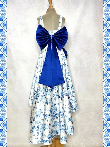 The back of our blue floral set is all about the drama of this oversized, deep blue satin bow. It's an unexpected detail that elevates the entire outfit.