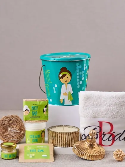 This spa-in-a-bucket is a complete pampering kit for the bride. It contains a personalized towel, body scrub, foot soak, a loofah, and a scented candle, all packed in a cute, reusable tin bucket.