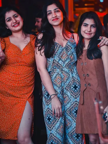 A group of friends posing together, enjoying the Bollywood night at The Fixx.