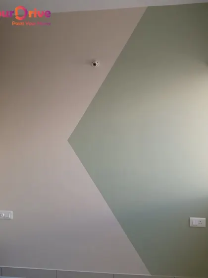 This wall features a two-tone geometric design using a simple diagonal pattern. The subtle color difference creates a modern and minimalist accent wall that adds character without being overpowering.