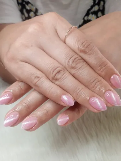 A classic pink cat eye manicure on almond-shaped nails.