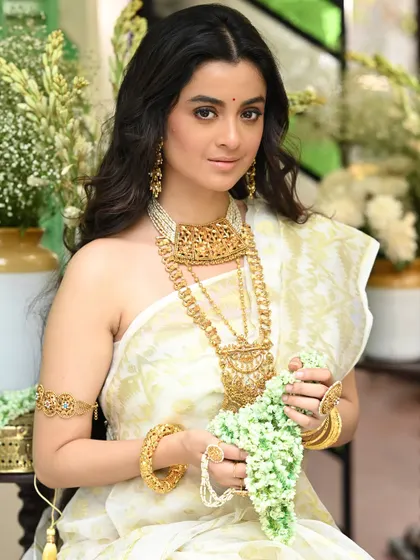Another shot of Darshana Banik holding a 'gajra' (flower garland). This pose adds a classic and graceful element to the portrait, emphasizing the traditional theme.