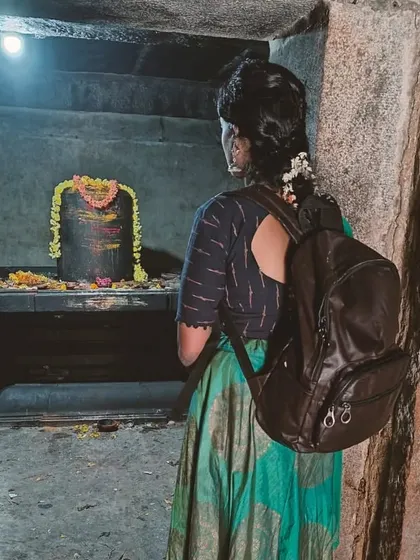 A moment of prayer in a quiet, ancient stone shrine.