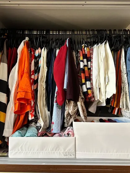 Pro Tip: Use the space below your hanging clothes. Adding organizers here acts like creating new drawers, making the full depth of your wardrobe accessible.