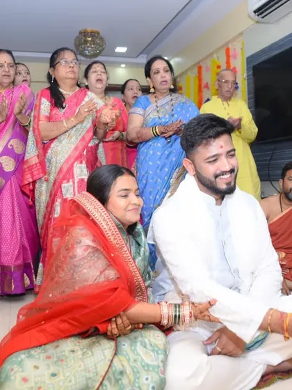 A couple participates in a Satyanarayana Puja, often performed after a wedding.