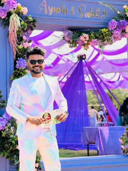 A welcoming pose at the entrance of a beautifully decorated venue.