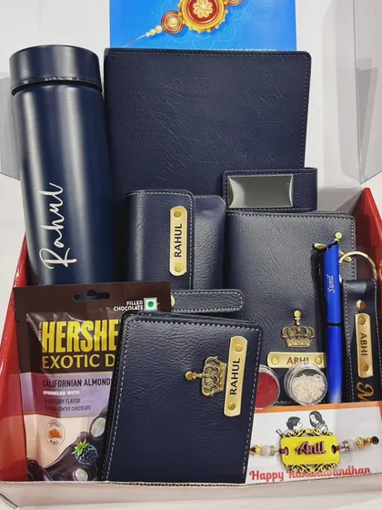 This comprehensive Rakhi combo for a brother is packed with value. It features a full set of personalized blue leather accessories including a wallet, passport cover, keychain, and more, plus a rakhi and chocolates.