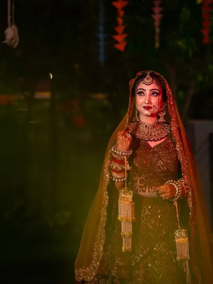 A dramatic bridal portrait taken at night, with creative lighting to make the bride stand out.