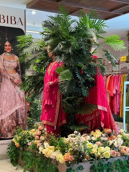 Another angle of our work for Biba, showing how the lush greenery and flowers create an immersive and high-end shopping experience, making the clothing displays pop.