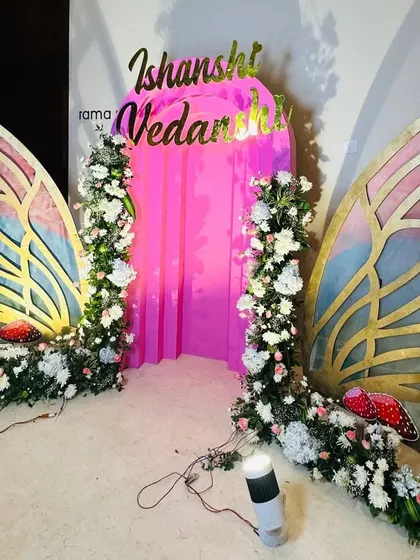 An angled view of the butterfly wing backdrop, showing the gold detailing on the wings and the spotlights used to illuminate them.