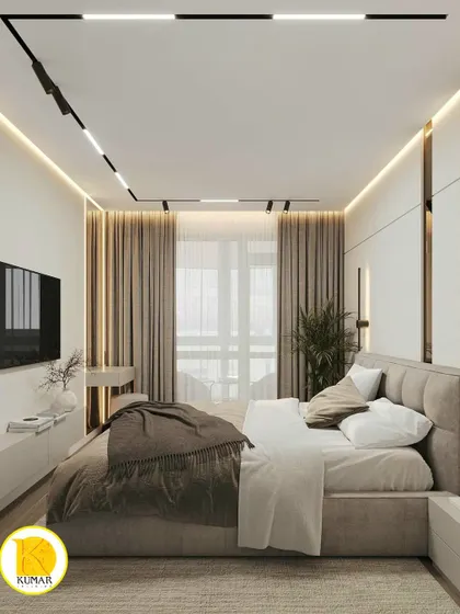 A wide shot of the bedroom, showing the balance of different lighting sources, including track lights and ambient cove lighting.