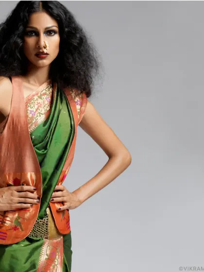 Vibrant poise meets contemporary chic. A studio shot of supermodel Nethra Raghuraman, blending a traditional Paithani saree with a modern jacket.