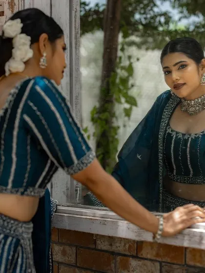 A mirror shot showing the beautiful hairstyle and the flawless makeup from the back.