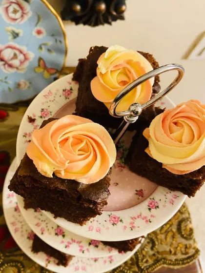An elegant presentation of my super moist chocolate cake squares with dual-toned rosettes, perfect for a high tea party dessert table.