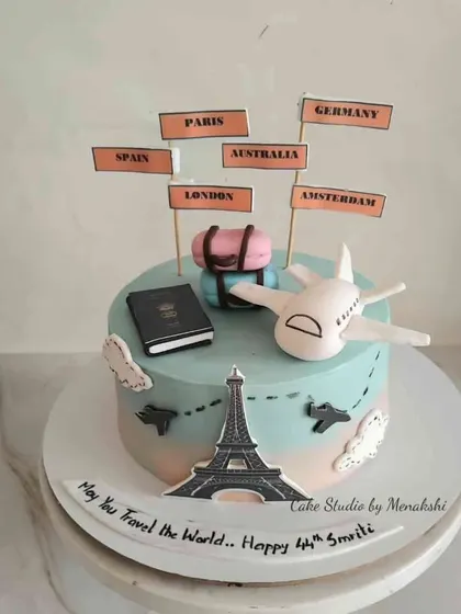 A travel themed cake for someone with wanderlust. This minimal fondant cake is decorated with an airplane, passport, and signs pointing to dream destinations.