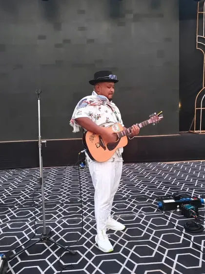 Getting ready for a performance at a large-scale wedding event. The grand stage and decor show the level of production we can be a part of.