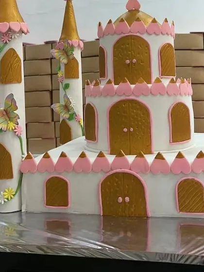 Another view of the grand palace cake, showing the intricate details of the towers and windows before it's set up at the party.