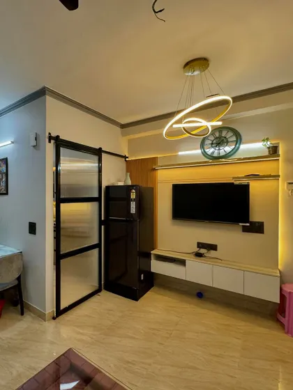 For this compact living area, I designed a clean, floating TV cabinet and used a modern ring chandelier to add a stylish touch without overwhelming the space.