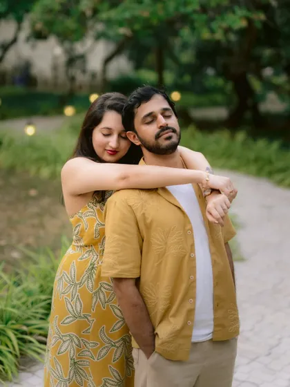 A tender moment between a couple in a park, showcasing their relaxed and natural chemistry.