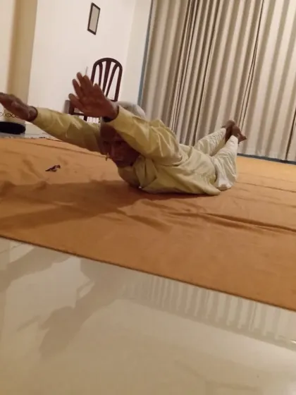 Demonstrating incredible strength and control in a variation of Salabhasana, the locust pose.