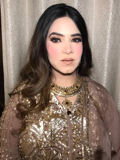 A full shot of the client in her nude and gold outfit, her choker adding a touch of royalty.