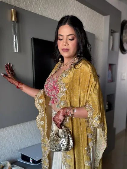 A full shot of this indo-western look, perfect for a sangeet or mehendi, featuring a mustard cape and embroidered blouse.