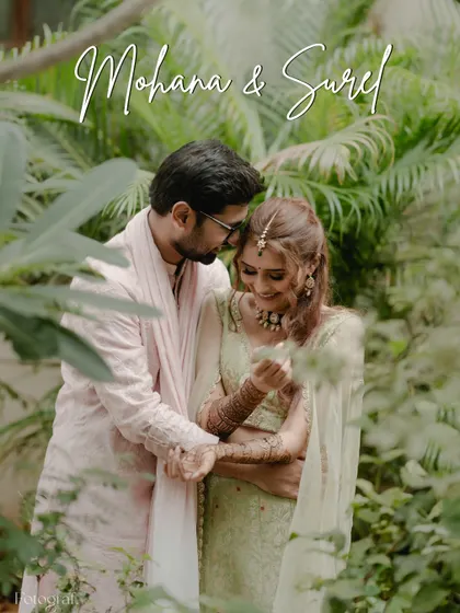 A tender moment framed by lush greenery. The couple shares a quiet embrace, their expressions full of affection and happiness.