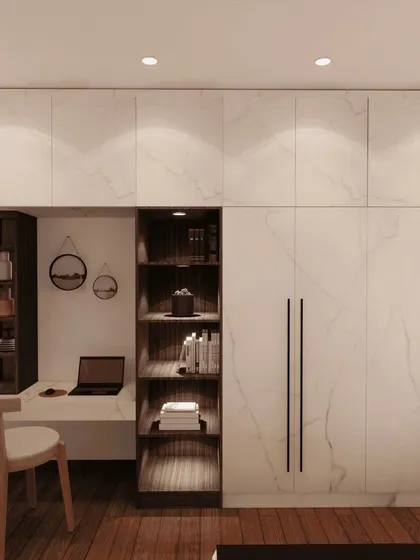A 3D render of a hinged wardrobe with a built-in study nook. The white marble-finish laminate and dark wood accents create a sophisticated and highly functional design for a modern bedroom.