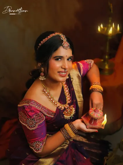 A close-up from the Diwali concept shoot with Anjana. Holding a traditional lamp, her makeup glows in the warm light, creating a festive and divine atmosphere.