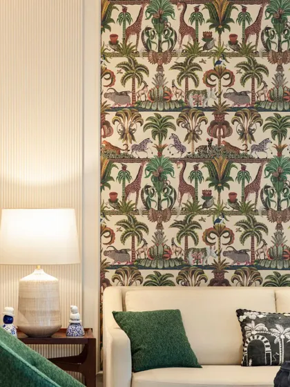 A detail of a living room featuring a vibrant, jungle-themed wallpaper panel next to a subtly ribbed wall, showcasing a playful mix of pattern and texture.