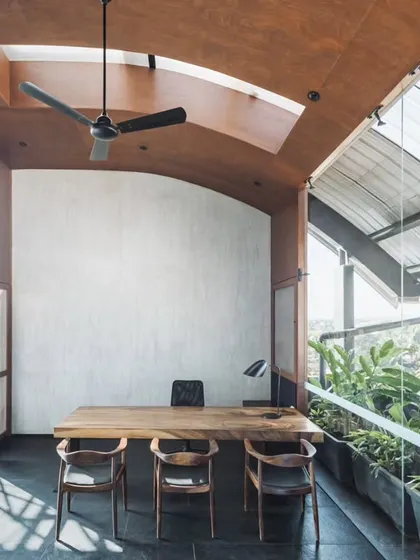 We call this project the 'Terrace Office' for its stunning panoramic views and connection to the outdoors. The director's cabin is a glass box with a vaulted wooden ceiling and its own skylight, offering a sense of openness and an abundance of natural light.