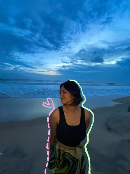 A moody evening shot at the beach, with a neon-style outline doodle that adds a cool, modern touch.