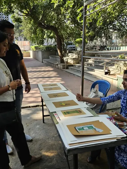 Interacting with visitors at the outdoor art event. It's a great way to get direct feedback and share the stories behind my drawings.