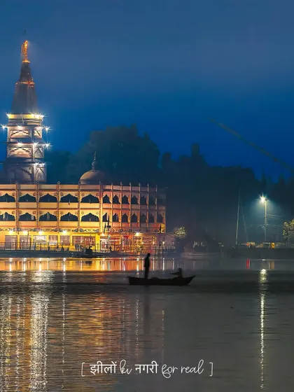 Bhopal, the city of lakes, is truly magical at night. This image captures the serene beauty of the lake with the temple lights reflecting on the water, showing the city's picturesque quality.