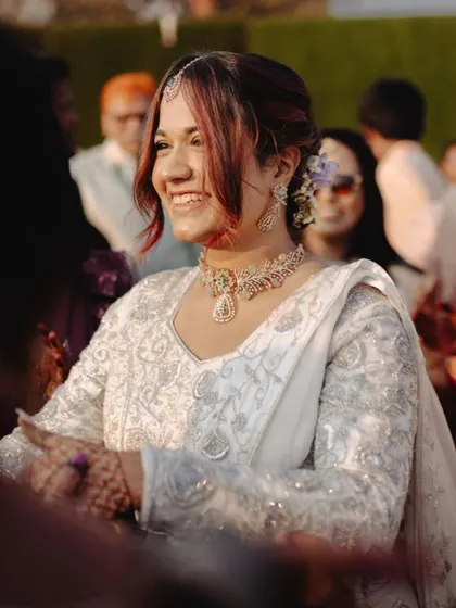 Another candid shot from the wedding, showing her beautiful white outfit and the soft, elegant updo.