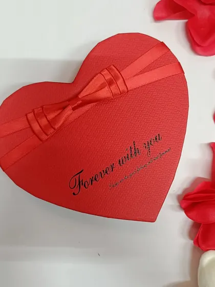The heart-shaped box itself is beautifully designed with a ribbon and the message 'Forever with you.'