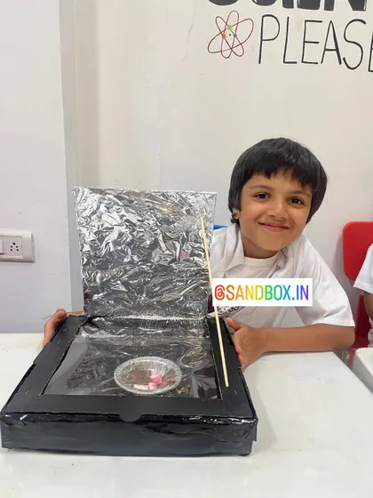 This young innovator is excited to test his solar cooker. We encourage kids to think about sustainable solutions and how science can help our planet.