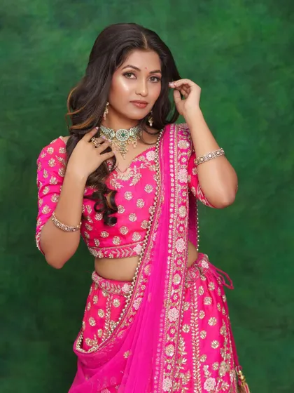 A full-length view of the model in a pink lehenga, showcasing the complete no-makeup look.