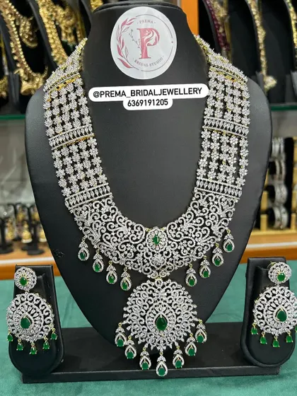 A grand AD and emerald set with a large statement pendant.