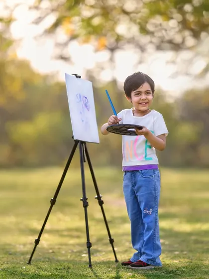 Introducing the little artist. With an easel, palette, and brush, this themed shoot lets your child's creative spirit shine in a beautiful outdoor setting.