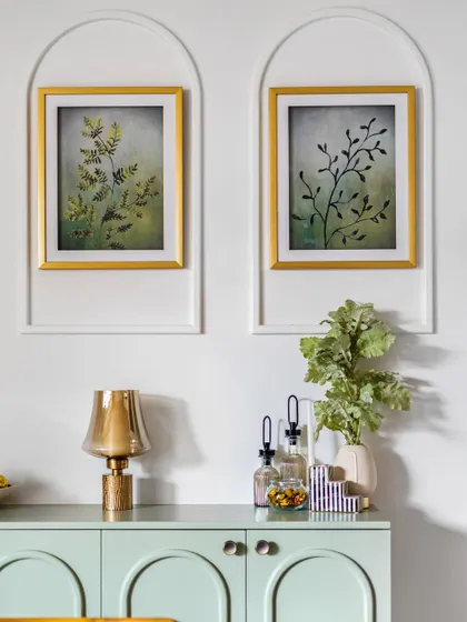 And the arches continue. Here, we used them to frame artwork above the mint green crockery unit, creating a cohesive design language throughout the 'Tatvam' project.