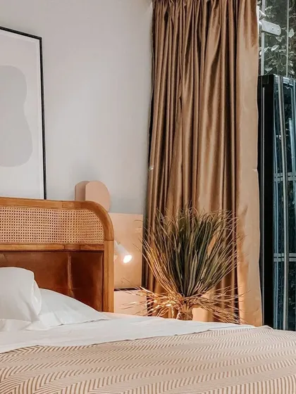 A side view of the Tierra Bed, highlighting the beautiful contrast between the warm wood, natural rattan, and the soft textures of the bedding. This is where comfort meets sophisticated, nature-inspired design.