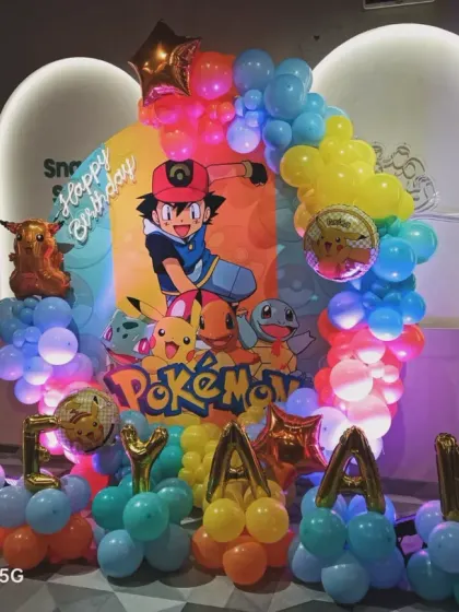 Another shot of the Pokémon party setup, including the light-up marquee number '5' and balloon columns spelling out the birthday boy's name.