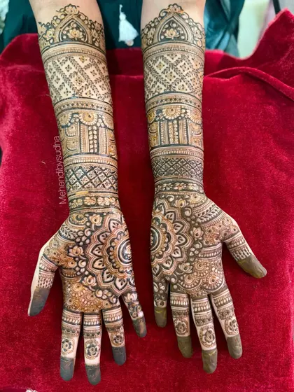 The full design on a red background, highlighting the intricate bands and patterns on the forearms.