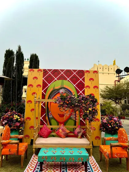 For this Mehendi, I used vibrant pop art featuring traditional Rajasthani figures to create a fun and quirky photo backdrop. It's about adding personality and a touch of the unexpected to the decor.