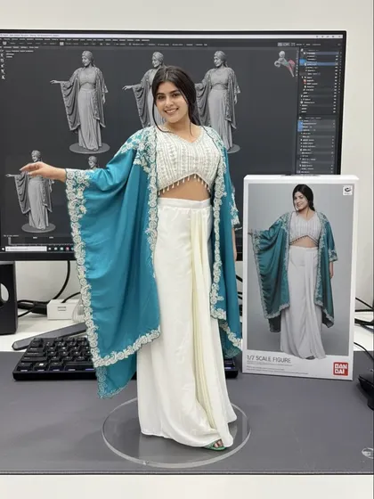 This white and teal Indo-Western outfit with a hand-embroidered cape is one of our signature styles, now immortalized as a collectible figure.