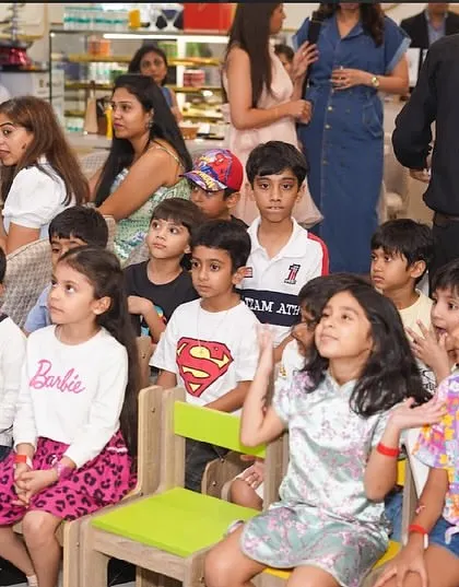 Children and adults sit together, captivated by the entertainment. Our parties are designed for everyone to enjoy.