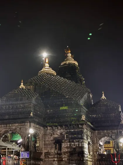A night shot of a temple, possibly in Ujjain, with the moon shining brightly above its spires. This showcases my low light photography skills.