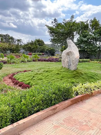 A natural rock sculpture is given a place of prominence on a grassy mound at 'The Sanctuary', illustrating how we incorporate existing or natural elements into our designs.