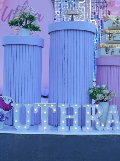 Another angle of the unicorn party decor, showing the custom-printed plinths and marquee letters.